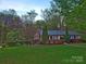 Charming brick ranch-style home with a well-maintained lawn and beautiful landscaping at 1552 10Th Street Nw Pl, Hickory, NC 28601