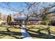 Charming single-story brick home with a metal roof, well-manicured landscaping, and inviting blue door at 1552 10Th Street Nw Pl, Hickory, NC 28601