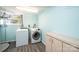 Laundry room with modern washer and dryer, storage cabinet, and a bright window at 1552 10Th Street Nw Pl, Hickory, NC 28601