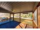 Relaxing covered porch with wooden floor and ceiling fan, offering serene views of the surrounding landscape at 1552 10Th Street Nw Pl, Hickory, NC 28601