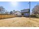 Large backyard with wood fence and house in the background on a sunny day at 1824 Haines St, Charlotte, NC 28216