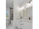 Modern bathroom features double vanity, marble floors, shower, and soaking tub with natural light at 1824 Haines St, Charlotte, NC 28216