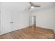 Bedroom features a ceiling fan, hardwood floors, and a closet, providing ample storage space at 1824 Haines St, Charlotte, NC 28216