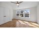 Bright bedroom features a ceiling fan, hardwood floors and three windows for ample natural light at 1824 Haines St, Charlotte, NC 28216