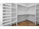 Walk-in closet with custom shelving and wood floor at 1824 Haines St, Charlotte, NC 28216