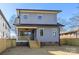 Two-story home featuring gray siding, wooden porch, and grass backyard in a neighborhood at 1824 Haines St, Charlotte, NC 28216