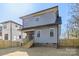 Angle view of a two-story home featuring gray siding, wood porch, and fenced-in backyard at 1824 Haines St, Charlotte, NC 28216