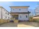 Rear of a two-story home featuring gray siding, wood porch, and grass lawn at 1824 Haines St, Charlotte, NC 28216