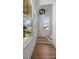 Bright foyer with hardwood floors, decorative trim, and large windows at 1824 Haines St, Charlotte, NC 28216