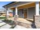 Inviting front porch with wood ceiling, brick pillars, and ceiling fans at 1824 Haines St, Charlotte, NC 28216