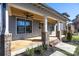Inviting front porch with wood ceiling, brick pillars, and ceiling fans at 1824 Haines St, Charlotte, NC 28216