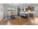 Bright kitchen with stainless steel appliances, a large island with seating, and hardwood flooring at 1824 Haines St, Charlotte, NC 28216