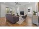 Bright living room featuring a fireplace, hardwood floors, comfortable seating, and large windows at 1824 Haines St, Charlotte, NC 28216