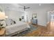 Spacious main bedroom features hardwood floors, a ceiling fan, and neutral paint tones at 1824 Haines St, Charlotte, NC 28216