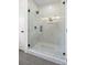 Modern shower featuring glass enclosure and sleek hardware in a bright, tiled bathroom at 1824 Haines St, Charlotte, NC 28216