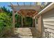 Covered outdoor patio area with stone flooring, wooden pergola, and ceiling fan at 3009 Scottcrest Way, Waxhaw, NC 28173