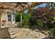 A covered back patio with a stone paver floor, wooden beam supports and a ceiling fan at 3009 Scottcrest Way, Waxhaw, NC 28173