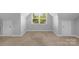 A carpeted bonus room with two doors and a window offering plenty of natural light at 3009 Scottcrest Way, Waxhaw, NC 28173