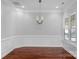 Bright dining room with hardwood floors, wainscoting detail, and a modern chandelier at 3009 Scottcrest Way, Waxhaw, NC 28173