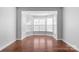 An empty room with hardwood floors and a bay window at 3009 Scottcrest Way, Waxhaw, NC 28173