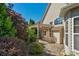 Backyard view of a house featuring a stone patio under a pergola with lush landscaping at 3009 Scottcrest Way, Waxhaw, NC 28173