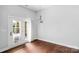 Sunlit room with hardwood floors, french doors and a modern pendant light at 3009 Scottcrest Way, Waxhaw, NC 28173