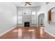 Light-filled living room with hardwood floors, fireplace, and multiple windows with shutters at 3009 Scottcrest Way, Waxhaw, NC 28173