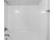 Bright white stand-up shower with shower head, faucet, and in-shower shelf at 3009 Scottcrest Way, Waxhaw, NC 28173