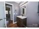 Modern bathroom featuring a floating vanity and wood flooring at 3029 Wendover Nw Rd, Concord, NC 28027