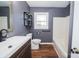 Updated bathroom with modern fixtures, bathtub, and wood flooring at 3029 Wendover Nw Rd, Concord, NC 28027