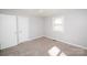 Cozy bedroom featuring plush carpet with a closet and a window at 3029 Wendover Nw Rd, Concord, NC 28027