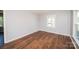 Cozy bedroom featuring hardwood floors, neutral walls, and bright, natural lighting at 3029 Wendover Nw Rd, Concord, NC 28027