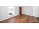 Bright bedroom featuring hardwood floors, neutral walls, and a window with natural light at 3029 Wendover Nw Rd, Concord, NC 28027