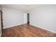 Inviting bedroom featuring hardwood floors, neutral walls, and a closet at 3029 Wendover Nw Rd, Concord, NC 28027