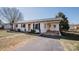 Charming single-story home with an attached carport and manicured landscaping at 3029 Wendover Nw Rd, Concord, NC 28027