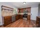 Well-equipped kitchen with stainless steel appliances and dark wood cabinets at 3029 Wendover Nw Rd, Concord, NC 28027