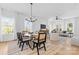 Bright dining area with a glass table, stylish chairs, and views into the living space at 3816 Odom Way, Charlotte, NC 28216