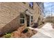 Exterior entrance of brick townhome featuring a sidewalk, and an exterior light fixture at 3816 Odom Way, Charlotte, NC 28216