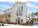 Modern two-story townhome with a combination of siding and brick, plus manicured landscaping at 3816 Odom Way, Charlotte, NC 28216