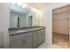 Bathroom featuring double granite sink vanities and a separate toilet room and walk-in closet at 4242 Plumeria Way, Fort Mill, SC 29707