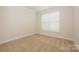 Cozy bedroom features neutral carpet and a window providing natural light at 4242 Plumeria Way, Fort Mill, SC 29707
