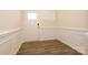 Welcoming entryway with white paneled walls, hardwood floors and a storm door at 4242 Plumeria Way, Fort Mill, SC 29707