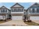 Inviting townhome showcases a two-car garage, stone accents, and a welcoming entrance at 4242 Plumeria Way, Fort Mill, SC 29707
