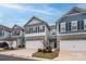 Charming townhomes featuring stone accents, two-car garages, and well-maintained landscaping at 4242 Plumeria Way, Fort Mill, SC 29707