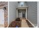 Charming front entrance with stylish door, stone accents, and well-maintained landscaping at 4242 Plumeria Way, Fort Mill, SC 29707