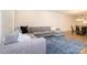 The living room offers a large sectional with accent pillows, complemented by a blue area rug at 4242 Plumeria Way, Fort Mill, SC 29707