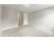 A spacious bedroom with neutral walls and carpet, featuring an adjoining hallway at 6464 Park Pond Dr # 7, Charlotte, NC 28262