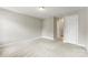 A neutral bedroom with a connecting hallway and neutral carpet at 6464 Park Pond Dr # 7, Charlotte, NC 28262