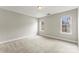 A neutral bedroom with two windows, perfect for natural light at 6464 Park Pond Dr # 7, Charlotte, NC 28262