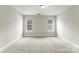 A neutral bedroom with two windows, providing ample natural light at 6464 Park Pond Dr # 7, Charlotte, NC 28262